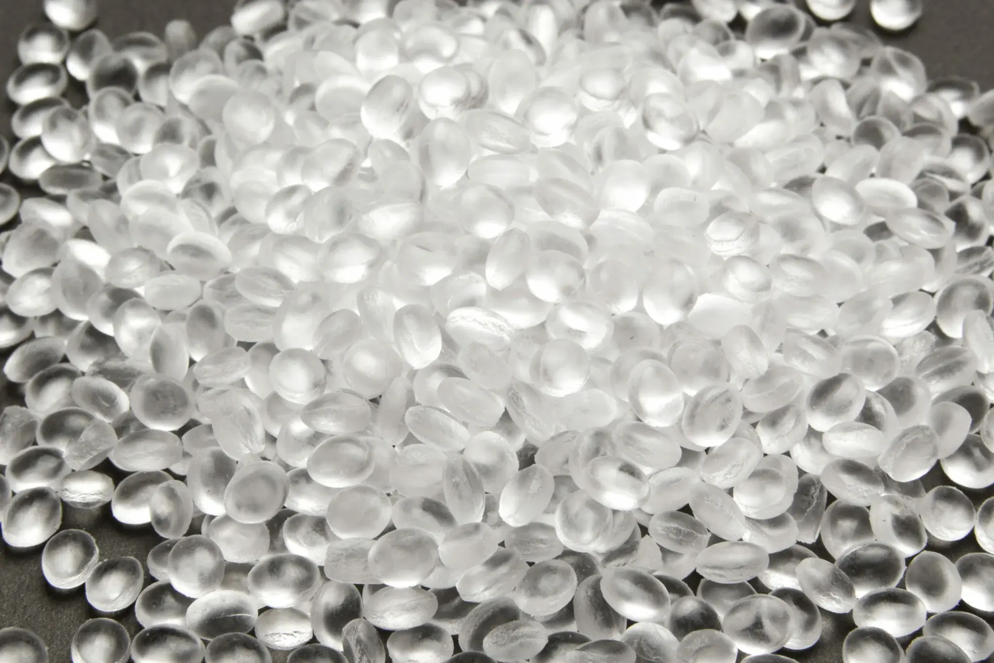 Transparent Polyethylene granules on dark .HDPE Plastic pellets.  Plastic Raw material . IDPE.