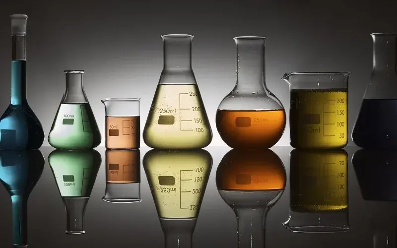 laboratory containers with multicolored liquids